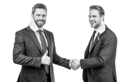 colleagues in mask shaking hands after business deal during coronavirus pandemic, partners.