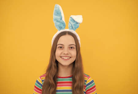 happy easter child girl in rabbit bunny ears smiling on holiday, easterの写真素材