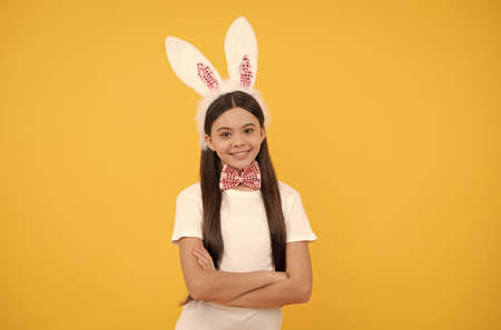 Easter hunt begins. happy easter. childhood happiness. child in rabbit ears and bow tie.の写真素材