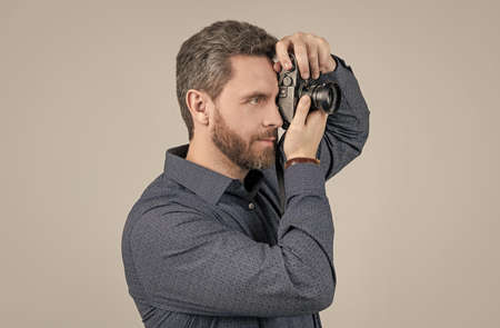 Worth capturing. Bearded man take photo with camera. Shooting session. Photography sessionの写真素材