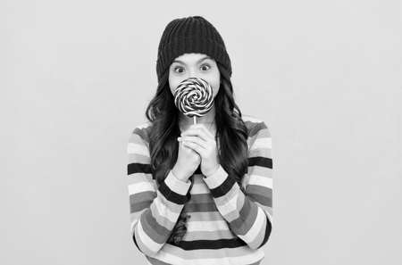 surprised teen girl with lollipop candy, sugar candyの写真素材