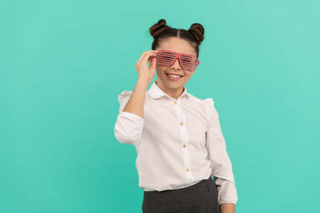 smiling funny kid in glamour eyeglasses with rhinestones. funky teen girl having fun