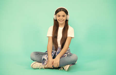 happy child girl listen to music in wireless headphones, device accessoryの写真素材