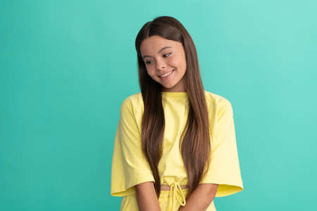smiling child with long hair on blue background, fashionの写真素材