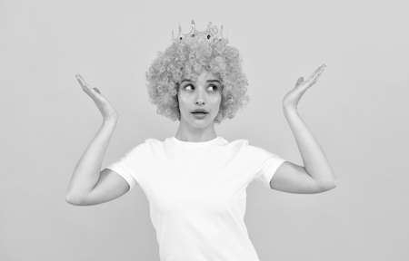 oh my god. april fools day. being smug. girls birthday party. amazed funny woman in wig and crownの写真素材