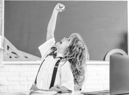 happy kid boy in bow tie study in school classrrom at blackboard, schoolの写真素材