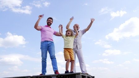 Happy family winners with paper planes enjoy success making winning gesture sky-high, victory
