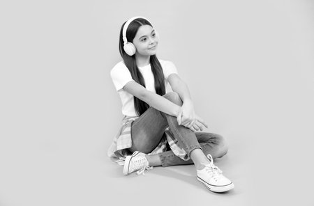 back to school. School is indeed fun. happy teen girl in headphones. listen to music.の写真素材