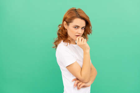 portrait of confident redhead lady on blue background. skincare concept. sexy womanの写真素材
