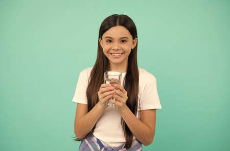 happy kid going to drink glass of water to stay hydrated and keep daily water balance, thirst.