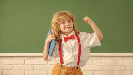 knowledge day. concept of education. nerd kid with long hair at blackboard. september 1.