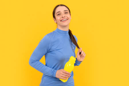 feel thirsty. young girl with sport plastic bottle. healthy lifestyle. water balance in body.の写真素材