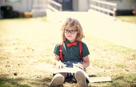 back to school. teen child study outdoor. happy childhood. nerd in glasses.の写真素材