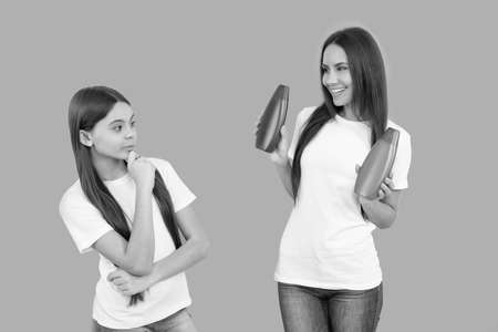 mother presenting cosmetic for teen daughter. suggest shower gel or shampoo bottle.の写真素材