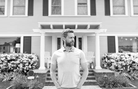 for sale. handsome realtor waiting for visitors. rent new home. ownership. confident man outsideの写真素材