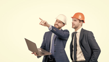 architects planning work. chief engineer and executive in hardhat use computer. ernet security....
