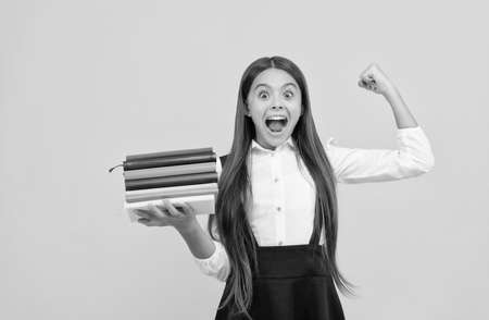 happy teen girl in school uniform hold book stack, successの写真素材