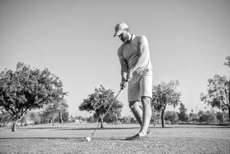 portrait of golfer in cap with golf club. people lifestyle. energetic man playing gameの写真素材