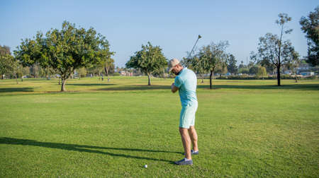 male golf player on professional course with green grass, golfの写真素材