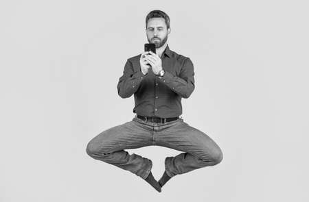 jump ceo meditating online. sms and instant messaging. yoga energetic businessman chat online.の写真素材