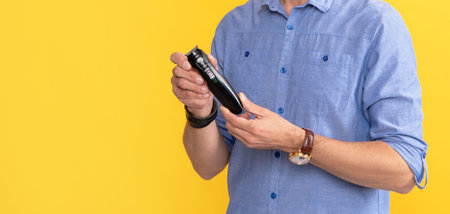 personal care and skincare. mens beauty. barbershop. man holding electric shaver.