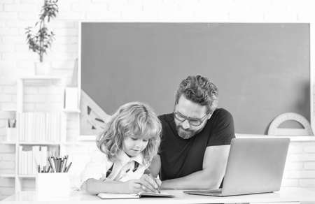 teacher and child study in classroom with laptop, fatherhood