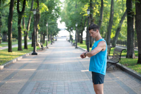 man checking time on smartwatch, copy spaceの写真素材