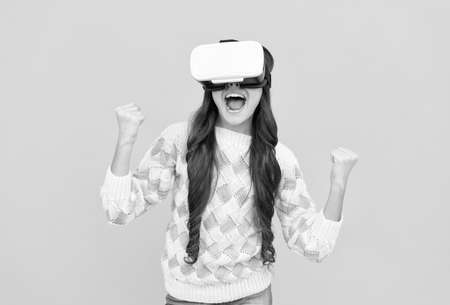 child in virtual reality goggles. modern wireless technology. childhood development. happy teen girl