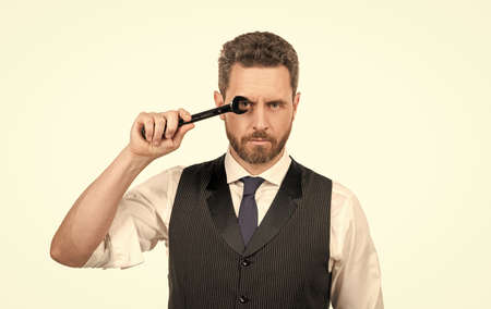 successful man in businesslike suit. entrepreneur with wrench isolated on white.
