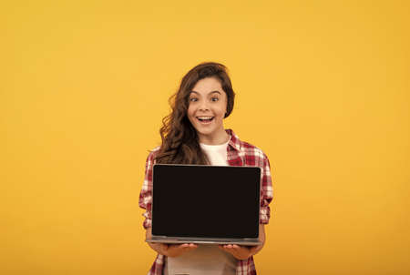 amazed smart child presenting laptop at school online lesson, school presentation