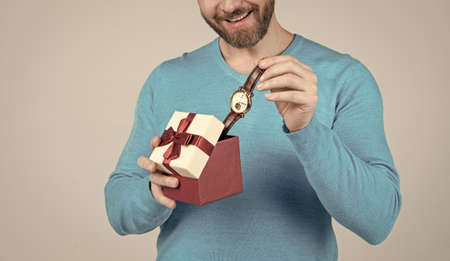 occasion greeting. guy showing gift box. corporate present. male fashion accessory.の写真素材