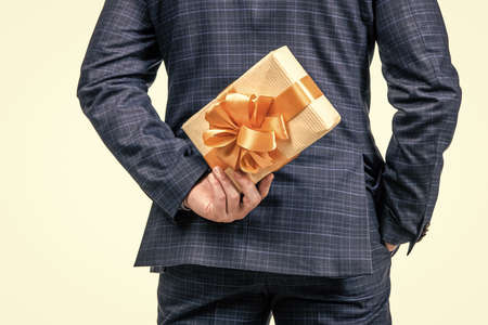 cropped businessman man hiding present box, back view, shoppingの写真素材