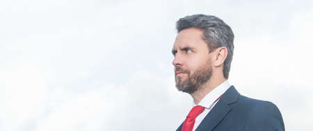 businessman in suit holding phone and hold laptopの写真素材