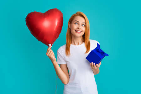 Holidays and celebration concept. Beautiful happy girl on birthday with gift. Young woman...