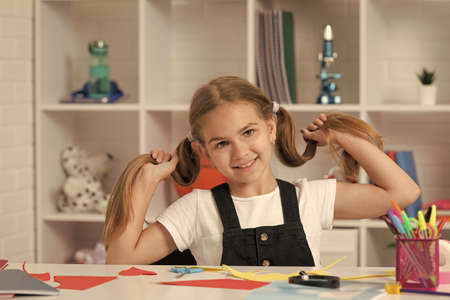 smiling teenager student hold pony tails. education. school girl with long hair. back to school.の写真素材