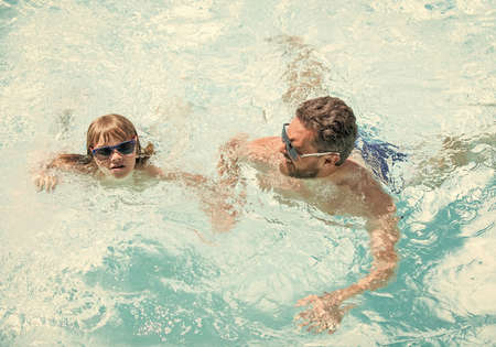 happy family of daddy and kid having fun in summer swimming pool, swimの写真素材