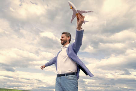 successful man in suit dreaming. entrepreneur ready for trip. freedom. mature boss with plane