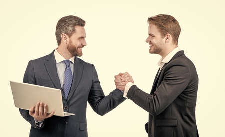 businessmen with laptop on meeting. boss and employee. partners after business deal.