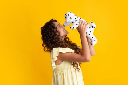 Childhood, toys and kids. Cute teen girl cuddling fluffy toy. Happy teenager, positive and smiling emotions of teen girl.の写真素材