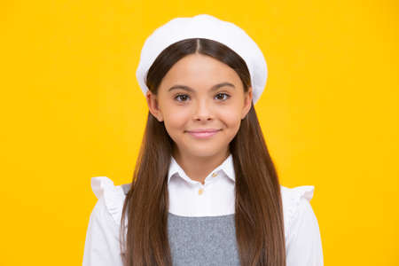 Happy girl face, positive and smiling emotions. Portrait of cute positive little girl isolated on yellow background. Attractive caucasian child smiling and looking at camera.の写真素材