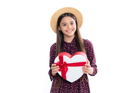 Child girl 12-14 years old with gift on isolated white background. Birthday, holiday concept. Teenager hold present box. Portrait of happy smiling teenage child girl.の写真素材