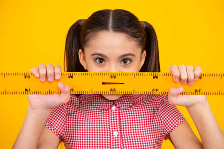 Teenager school girl study math or geometry lesson, measure the size. Mathematics ruler for...
