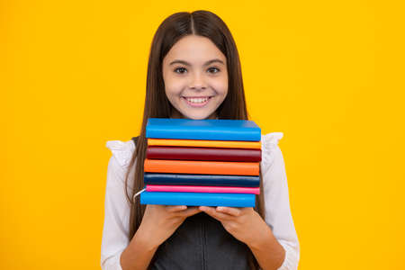 Schoolgirl with copy book posing on isolated background. Literature lesson, grammar school. Intellectual child reader.の写真素材