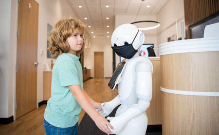 kid interact with robot as innovative technology, communicationの写真素材