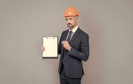 entrepreneur showing project. ceo with construction documents. mature boss with clipboardの写真素材