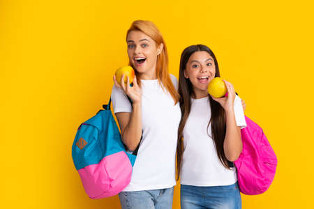 Mother and daughter schoolgirls with school bag ready to learn. Back to school. Mom and child on...