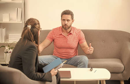 psychotherapy. guy talking to social worker. creating person portrait. life coach.の写真素材