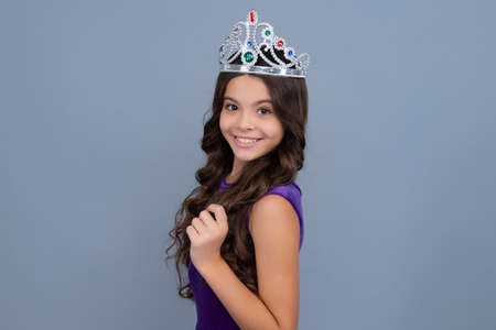Teenager princess child celebrates success win and victory. Teen girl in queen crown. Happy girl...