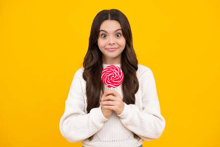 Teenage girl with lollipop, child eating sugar lollipops, kids sweets candy shop. Excited teenager...
