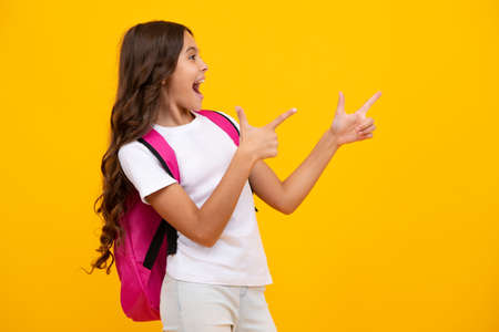 Amazed teen girl. School teen girl in with backpack. Teenager student on isolated background. Kids learning, education, studying and knowledge. Excited expression, cheerful and glad.の写真素材
